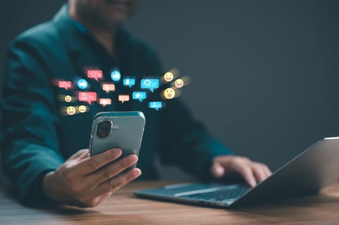 Digital composite features business person managing social media marketing campaigns through mobile device, computer